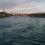 A picturesque view of River Ness with Inverness cityscape at dawn, showcasing historical architecture.